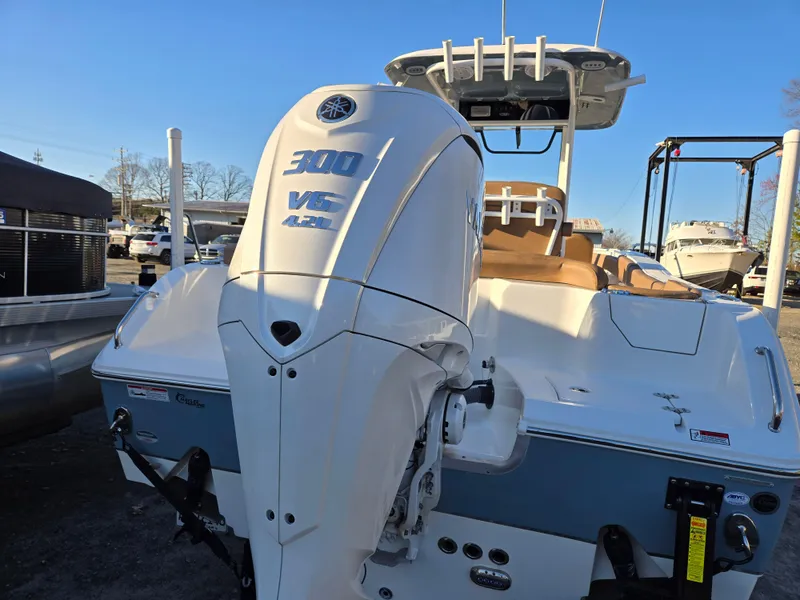 Slide: The Image of 2022 Sea Hunt Ultra 255 SE boat with powerful 300 V6 engine, docked outdoors. - 12