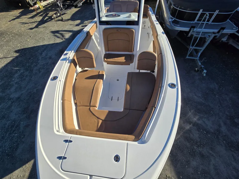 Slide: The Image of 2022 Sea Hunt Ultra 255 SE boat with tan seating and spacious deck. - 14