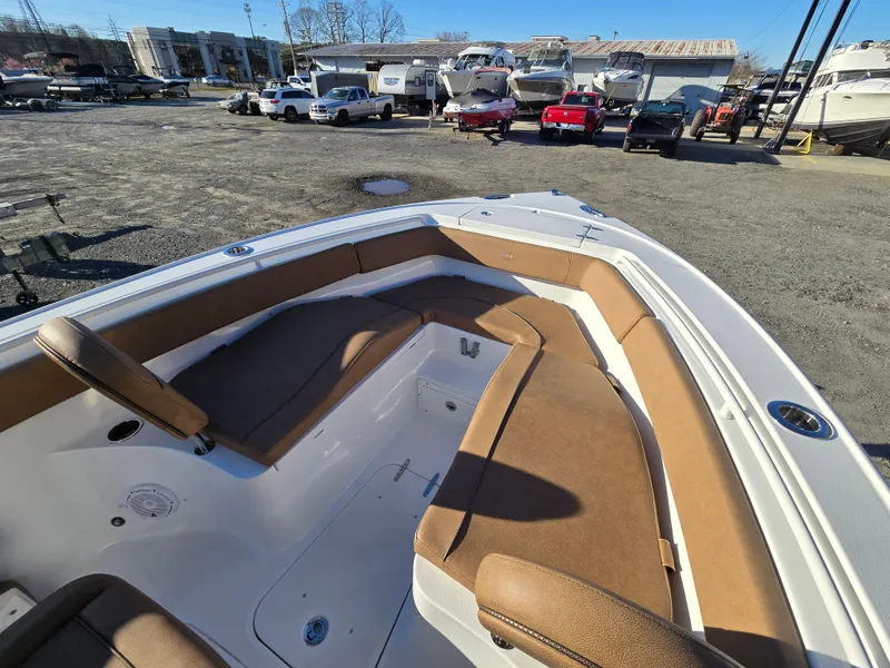 Slide: The Image of 2022 Sea Hunt Ultra 255 SE boat with spacious seating, displayed outdoors. - 15