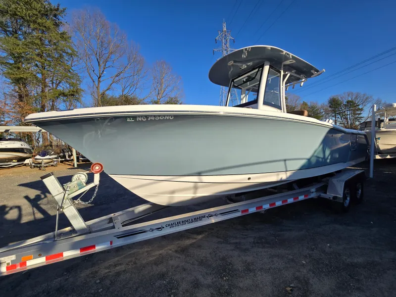 Slide: The Image of 2022 Sea Hunt Ultra 255 SE boat on trailer, parked outdoors. - 2