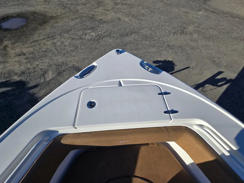 Slide: The Image of 2022 Sea Hunt Ultra 255 SE boat bow with seating and storage compartment. - 21