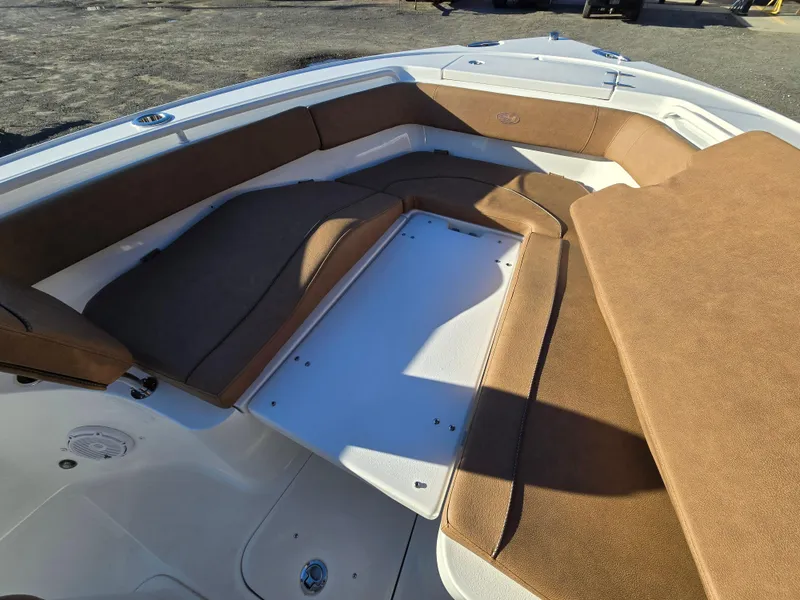 Slide: The Image of 2022 Sea Hunt Ultra 255 SE boat interior with cushioned seating. - 22