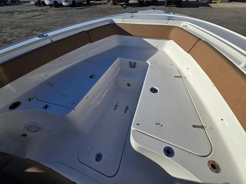 Slide: The Image of 2022 Sea Hunt Ultra 255 SE boat interior with spacious seating and storage compartments. - 23