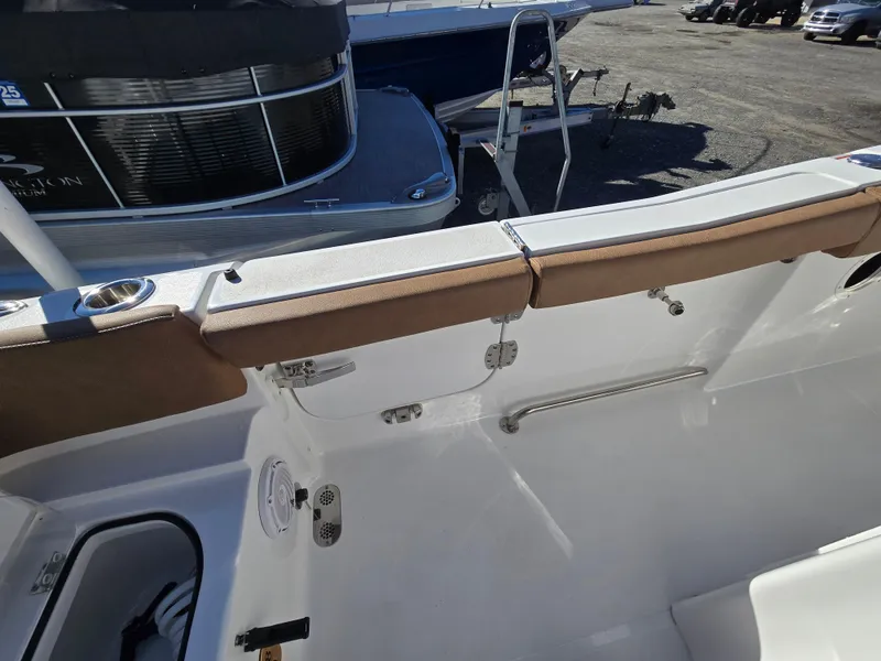 Slide: The Image of 2022 Sea Hunt Ultra 255 SE boat interior with seating and storage compartments. - 28