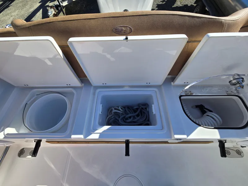 Slide: The Image of 2022 Sea Hunt Ultra 255 SE storage compartments with rope and hose. - 29