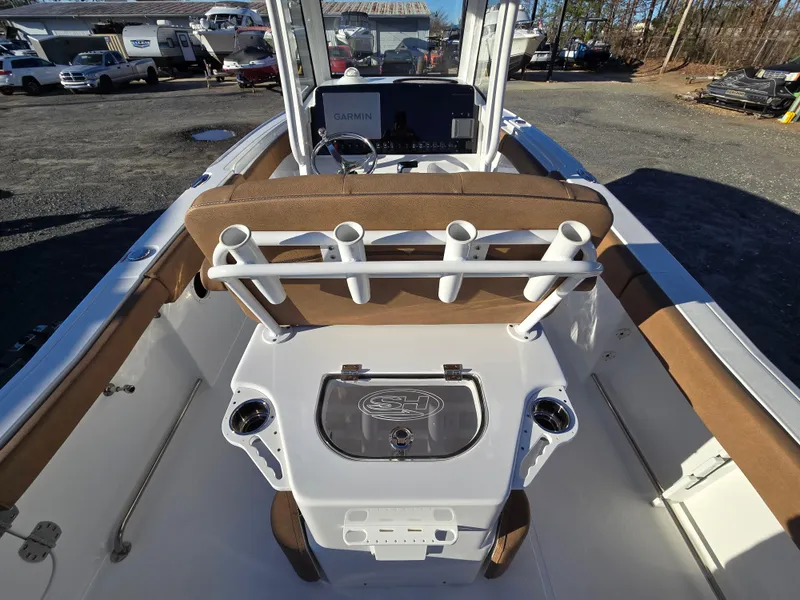 Slide: The Image of 2022 Sea Hunt Ultra 255 SE boat interior with rod holders and console. - 30