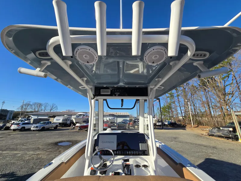 Slide: The Image of 2022 Sea Hunt Ultra 255 SE boat with T-top and console, parked outdoors. - 34