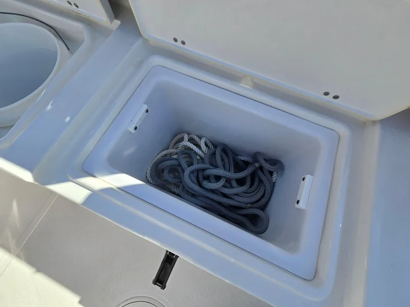 Slide: The Image of Storage compartment with rope on a 2022 Sea Hunt Ultra 255 SE boat. - 36