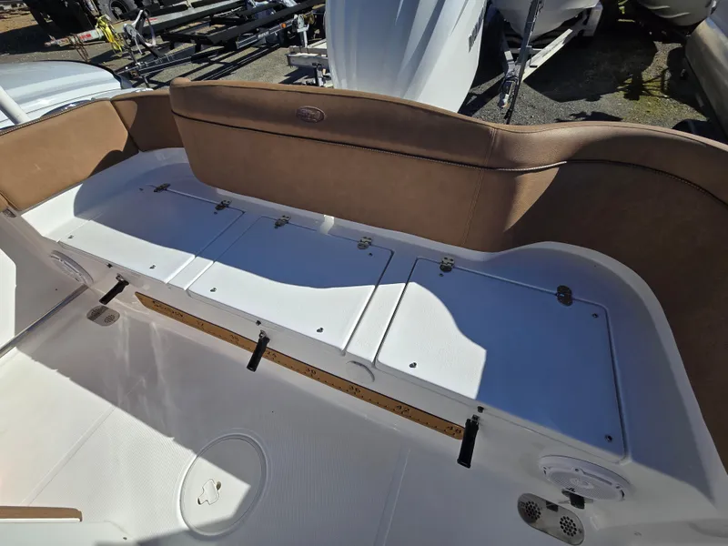 Slide: The Image of 2022 Sea Hunt Ultra 255 SE boat seating area with storage compartments. - 39