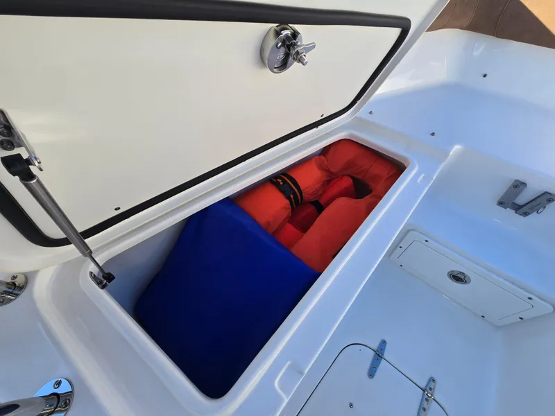 Slide: The Image of Storage compartment on 2022 Sea Hunt Ultra 255 SE boat with life jackets inside. - 41