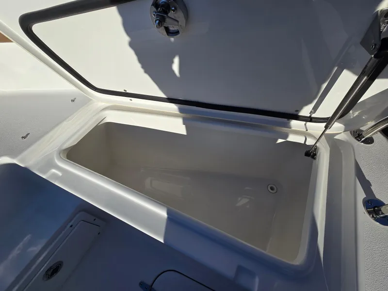 Slide: The Image of 2022 Sea Hunt Ultra 255 SE storage compartment open, showcasing interior space. - 42