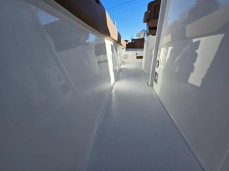 Slide: The Image of 2022 Sea Hunt Ultra 255 SE boat interior, showcasing sleek white deck and seating. - 45