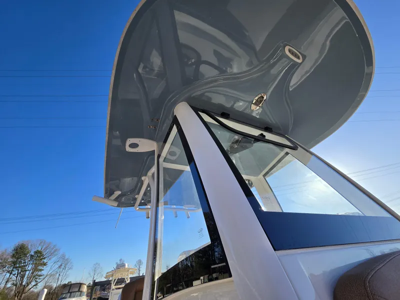 Slide: The Image of 2022 Sea Hunt Ultra 255 SE boat with sleek design and modern features under clear blue sky. - 47