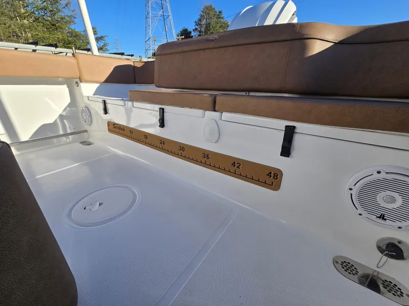 Slide: The Image of 2022 Sea Hunt Ultra 255 SE boat interior with seating and measurement scale. - 48