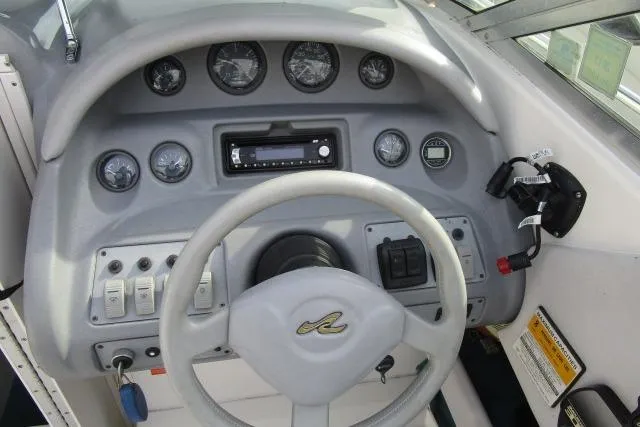 Slide: The Image of 1996 Sea Ray 240 Overnighter boat dashboard with steering wheel and instrument panel. - 10
