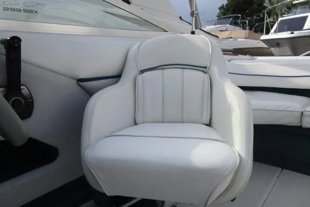 Slide: The Image of White captain's chair on a 1996 Sea Ray 240 Overnighter boat, showcasing sleek design. - 13