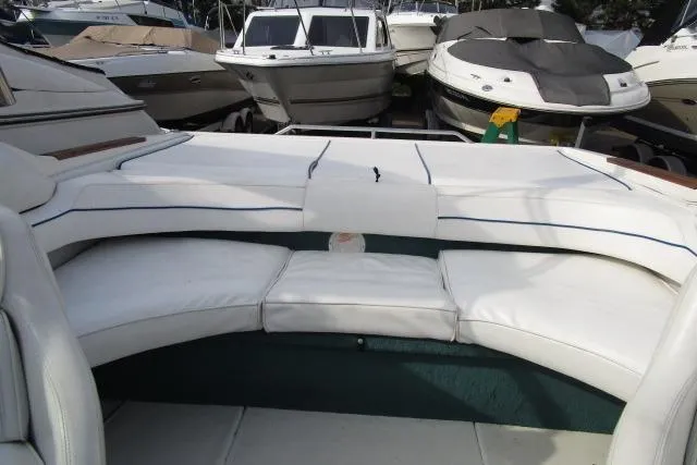 Slide: The Image of 1996 Sea Ray 240 Overnighter boat interior with white cushioned seating. - 14