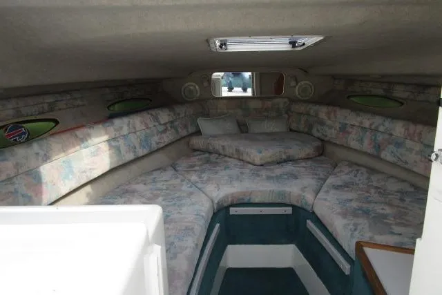 Slide: The Image of Interior cabin of a 1996 Sea Ray 240 Overnighter boat with cushioned seating. - 17