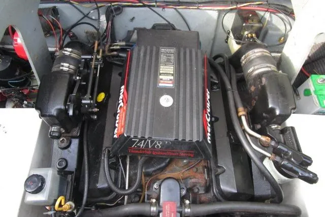 Slide: The Image of Engine compartment of a 1996 Sea Ray 240 Overnighter boat, featuring a MerCruiser 7.4L V8 engine. - 18