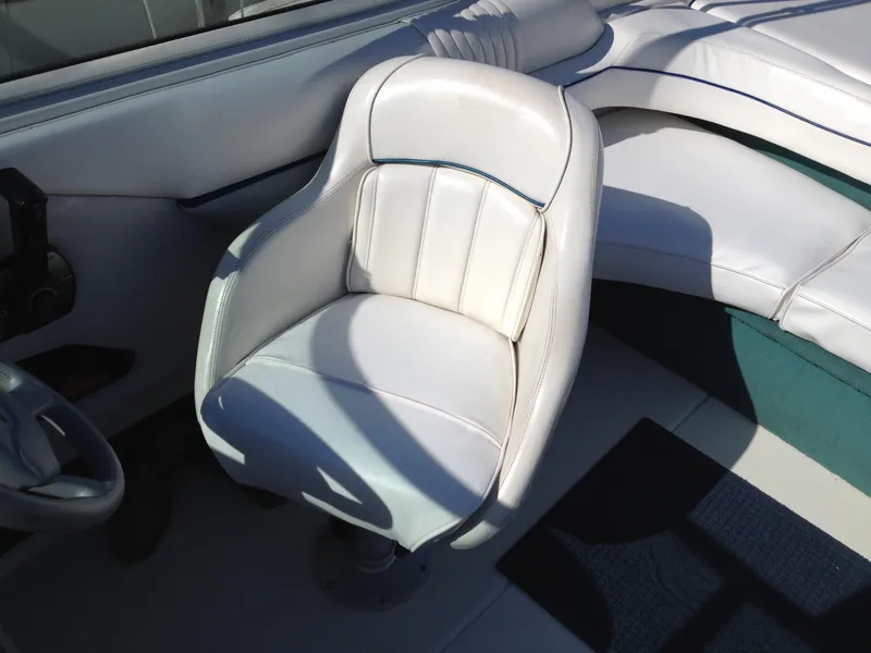 Slide: The Image of White leather seating in a 1996 Sea Ray 240 Overnighter boat interior. - 6