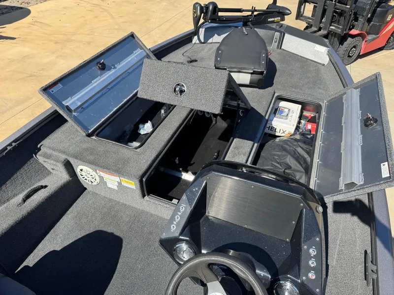 Slide: The Image of 2023 Crestliner XF 189 boat interior with open storage compartments and control panel. - 5