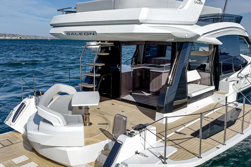 Slide: The Image of 2025 Galeon 500 Fly yacht on open water, featuring sleek design and luxurious deck space. - 14