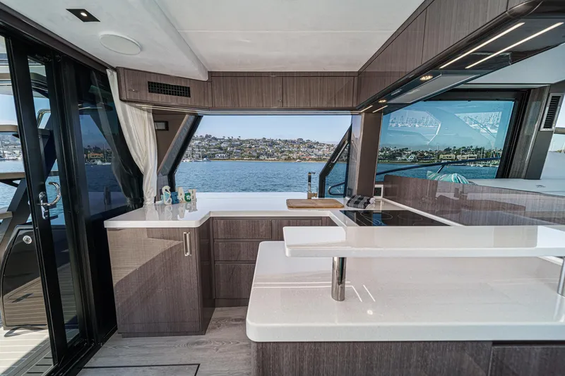 Slide: The Image of Luxurious interior of 2025 Galeon 500 Fly yacht with modern kitchen and scenic water view. - 35