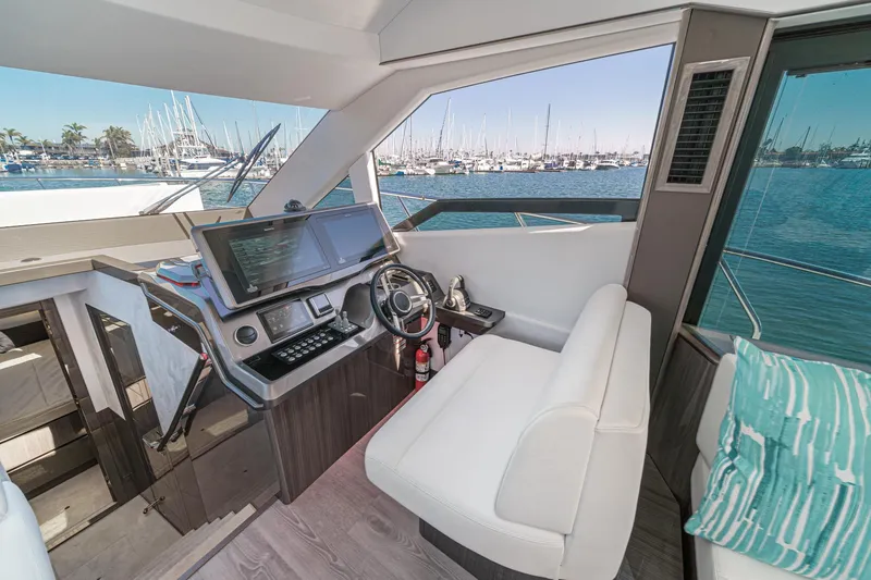 Slide: The Image of 2025 Galeon 500 Fly yacht interior with modern helm and marina view. - 40