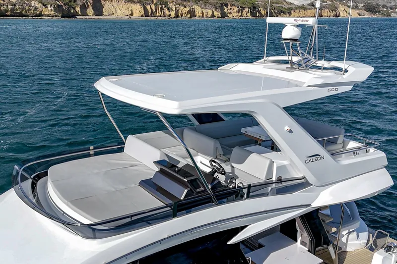Slide: The Image of 2025 Galeon 500 Fly yacht on water, featuring sleek design and spacious flybridge. - 9