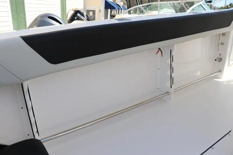 Slide: The Image of 2025 Edgewater 325CC boat interior with sleek white finish and stainless steel railings. - 12