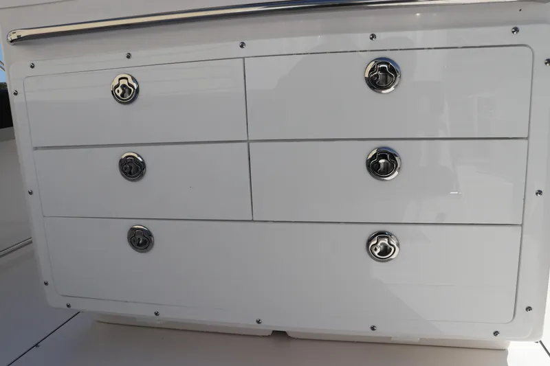 Slide: The Image of Open storage compartment on 2025 Edgewater 325CC boat. - 15