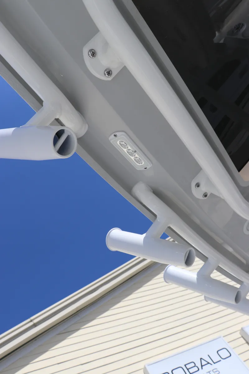 Slide: The Image of 2025 Edgewater 325CC boat detail with dealership signs in the background. - 26