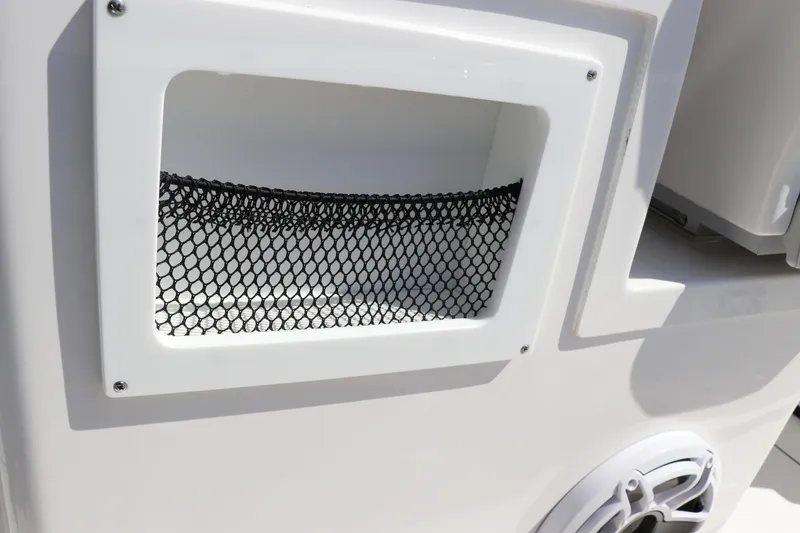 Slide: The Image of 2025 Edgewater 325CC boat speaker and rod holder against blue sky. - 28