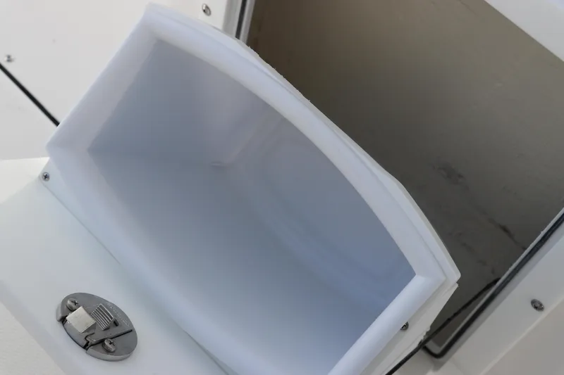 Slide: The Image of Edgewater 325CC 2025 boat storage compartment with secure latch. - 31