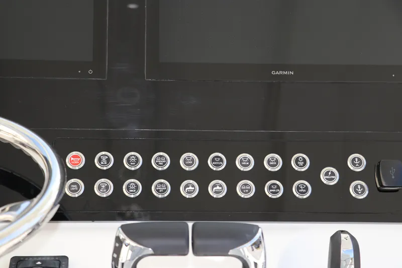 Slide: The Image of 2025 Edgewater 325CC boat dashboard with steering wheel and control panel. - 37