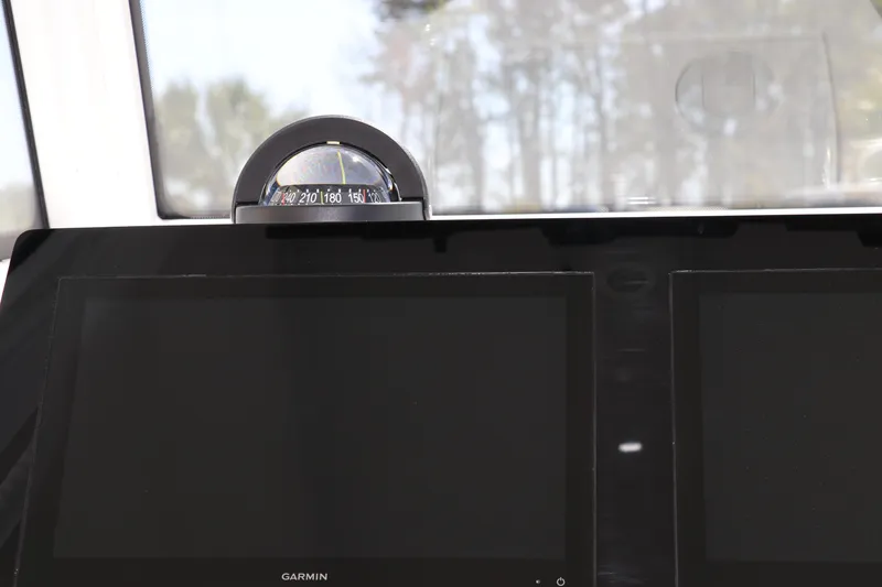 Slide: The Image of Steering wheel and controls of 2025 Edgewater 325CC boat. - 41