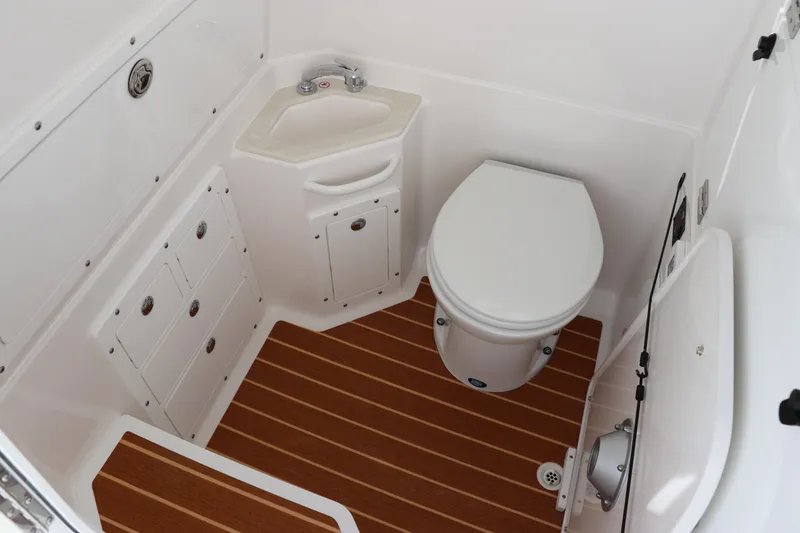 Slide: The Image of 2025 Edgewater 325CC boat, sleek white design with logo detail. - 48