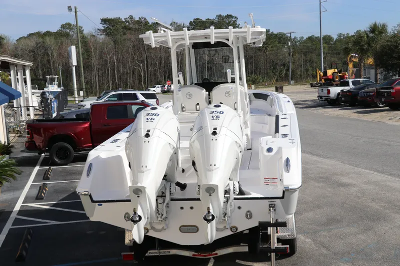 Slide: The Image of 2025 Edgewater 325CC boat with dual Yamaha engines on a trailer. - 6