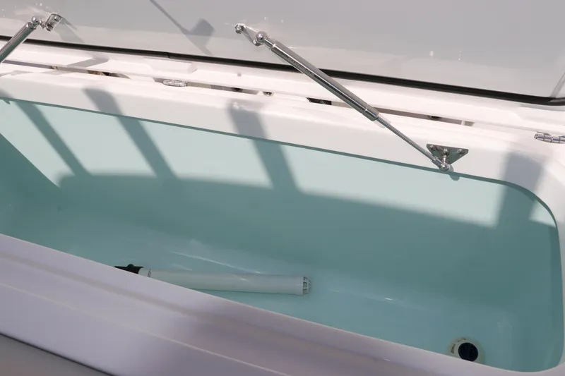Slide: The Image of 2025 Edgewater 325CC boat deck with rod holders and seating area. - 9