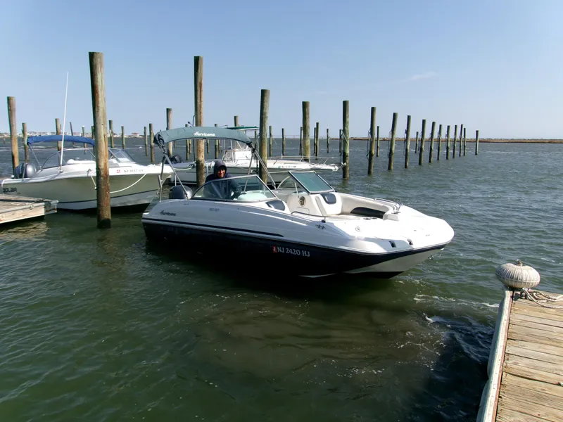 Slide: The Image of 2016 Hurricane SunDeck 187 OB boat docked in a marina. - 3