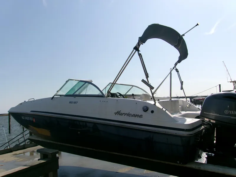 Slide: The Image of 2016 Hurricane SunDeck 187 OB boat docked with Yamaha outboard motor. - 5