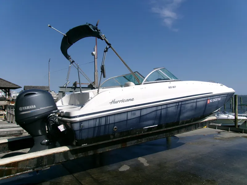 Slide: The Image of 2016 Hurricane SunDeck 187 OB boat with Yamaha outboard motor on a dock. - 7
