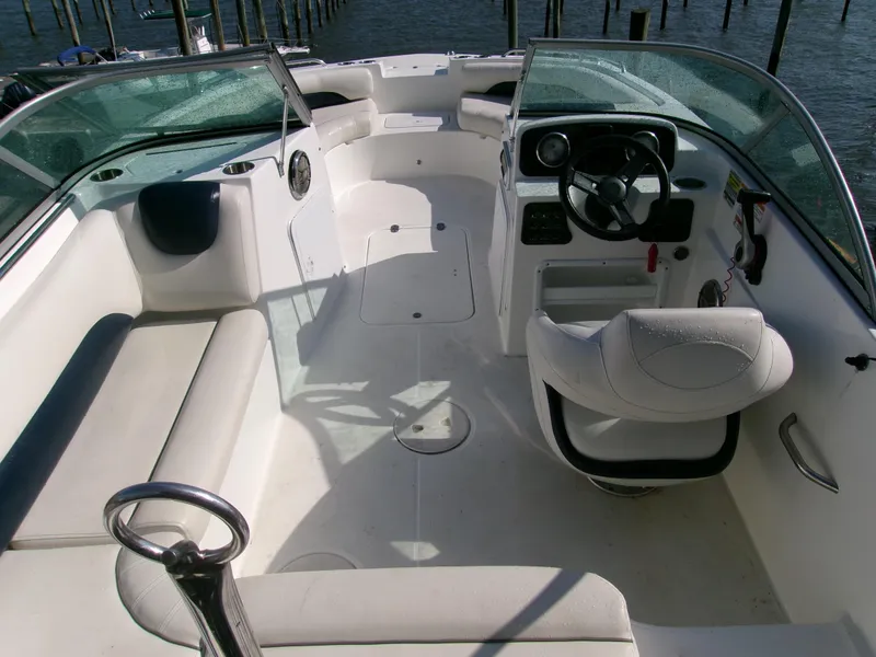 Slide: The Image of 2016 Hurricane SunDeck 187 OB boat interior with seating and steering console. - 8