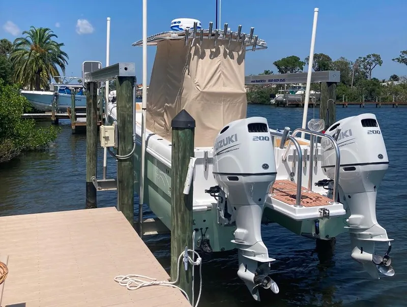 Slide: The Image of 2023 Prowler 25 boat docked with dual Suzuki 200 engines. - 14