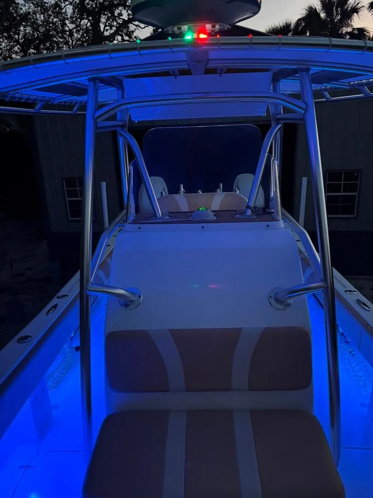 Slide: The Image of 2023 Prowler 25 boat with illuminated deck and seating at dusk. - 15