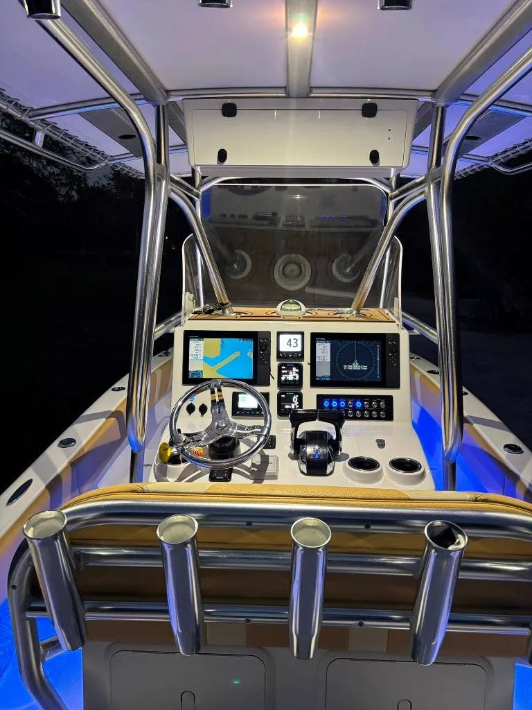 Slide: The Image of 2023 Prowler 25 boat cockpit with illuminated controls and navigation screens. - 16