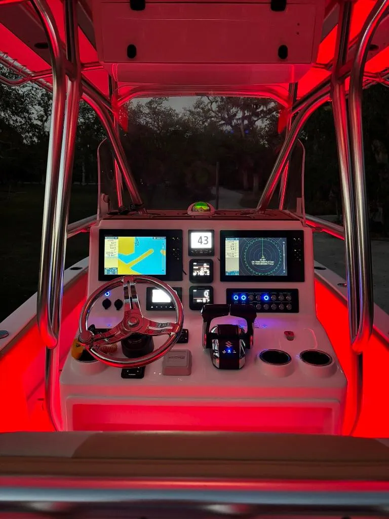 Slide: The Image of 2023 Prowler 25 boat dashboard with illuminated controls and navigation screens. - 17