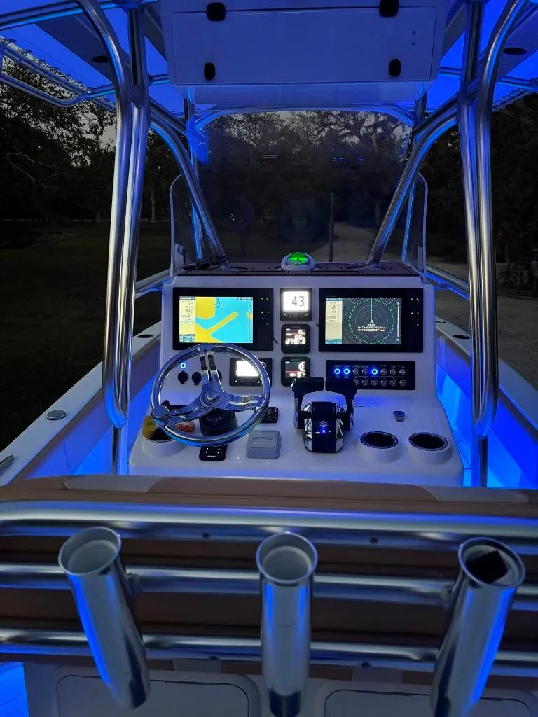 Slide: The Image of 2023 Prowler 25 boat cockpit with illuminated controls and navigation screens at night. - 18