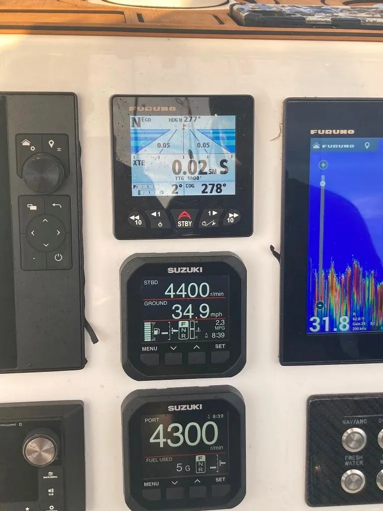 Slide: The Image of Boat dashboard with Suzuki and Furuno displays, Prowler 25, 2023 model. - 19