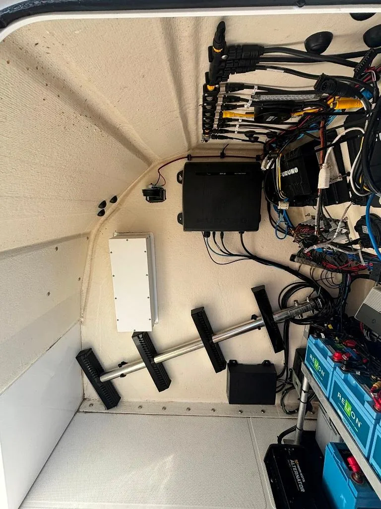 Slide: The Image of 2023 Prowler 25 interior wiring and equipment setup, showcasing organized cables and electronic components. - 31